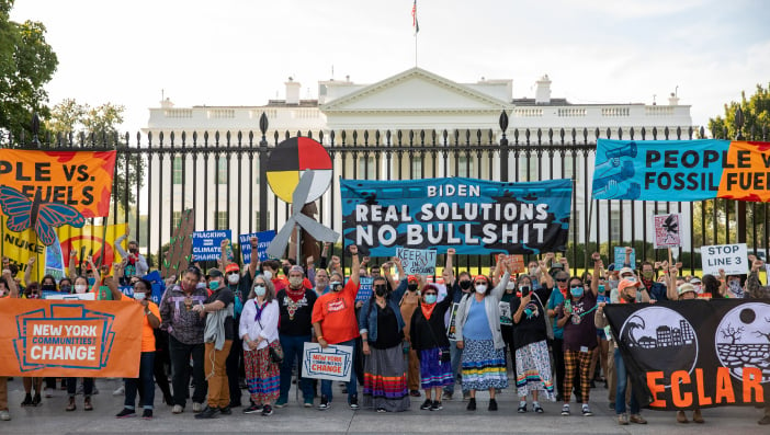 People who volunteered to be arrested stand in front of the White House during a march to protest against fossil fuels on Thursday, October 14, 2021 in Washington, DC.