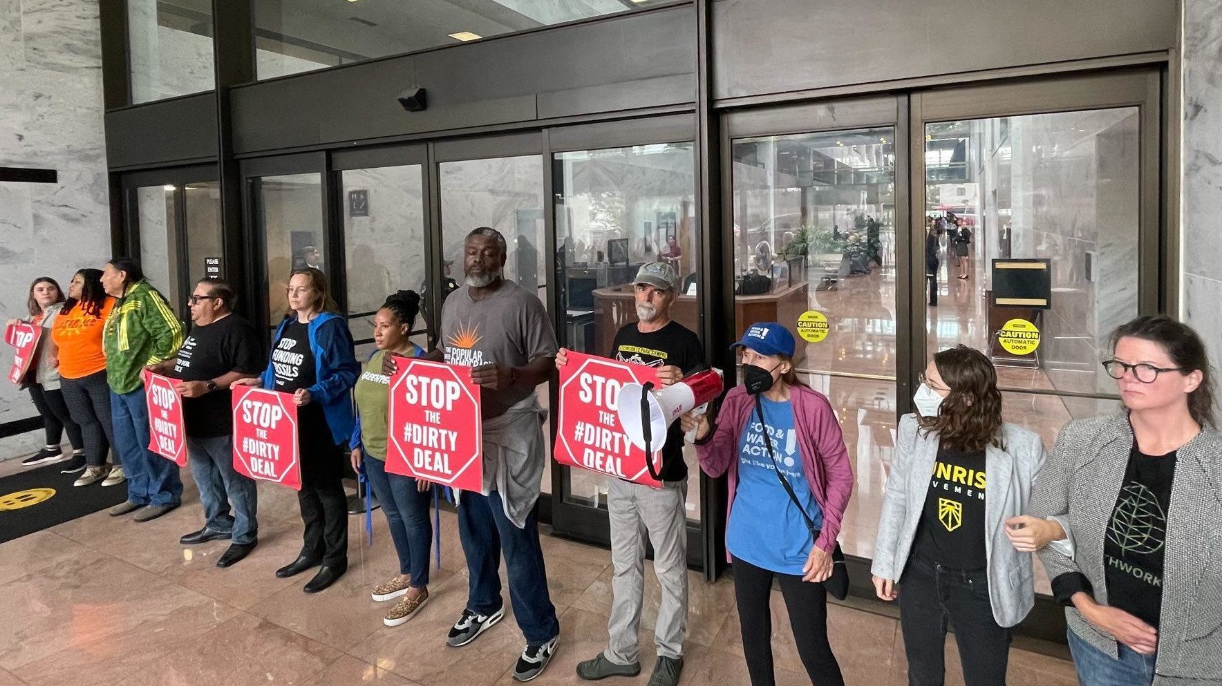 A line of climate group leaders stands in front of the doors of the Senate Building in D.C., including Food and Water Watch's Wenonah Hauter.