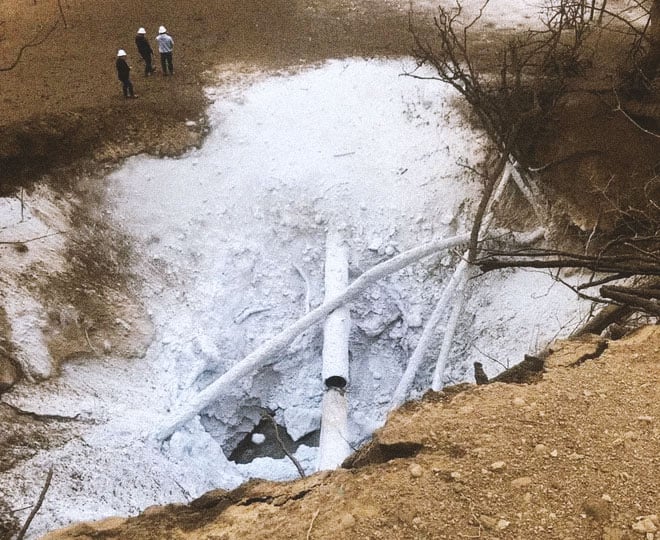 The burst pipeline in Satartia blew a crater in the ground and powdered the surrounding dirt with white.