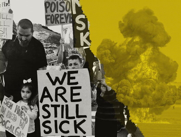At a rally, a man stands with children holding a sign that reads "We are still sick."