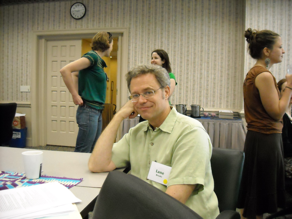 Lane sits at a table and smiles during the all-staff retreat.