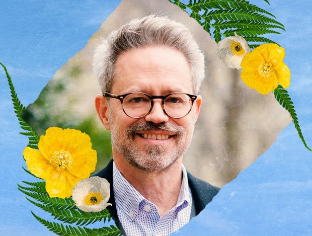 A photo of Lane framed by ferns and yellow poppies.