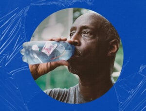 A Black man drinks from a clear plastic bottle of water.