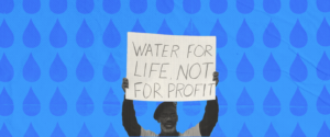 A protestor holds up a sign that says "Water for life not profit."