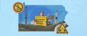 A person holds a sign saying "fracking = climate change" in a frame shaped like the state outline of Pennsylvania