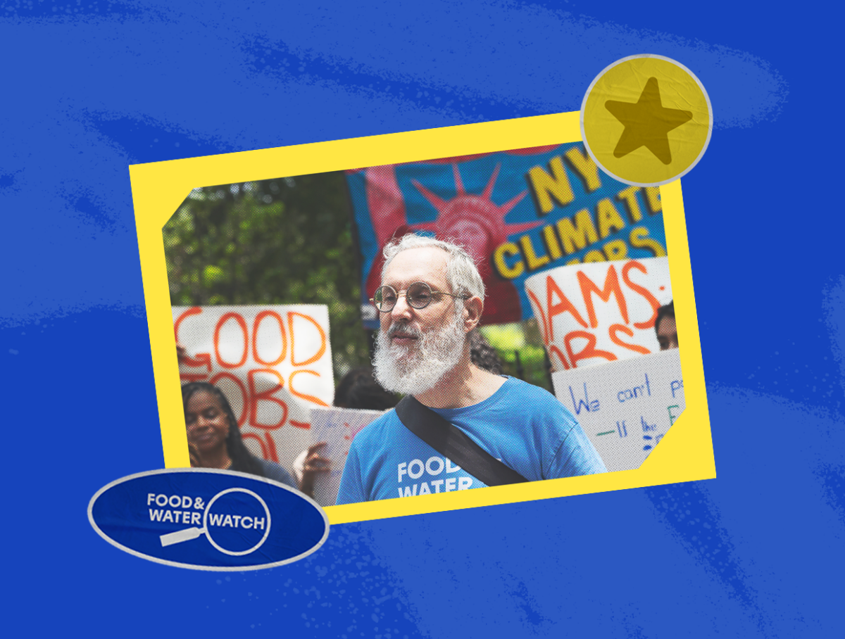 Ken Schles stands at a rally wearing a Food & Water Watch t-shirt.