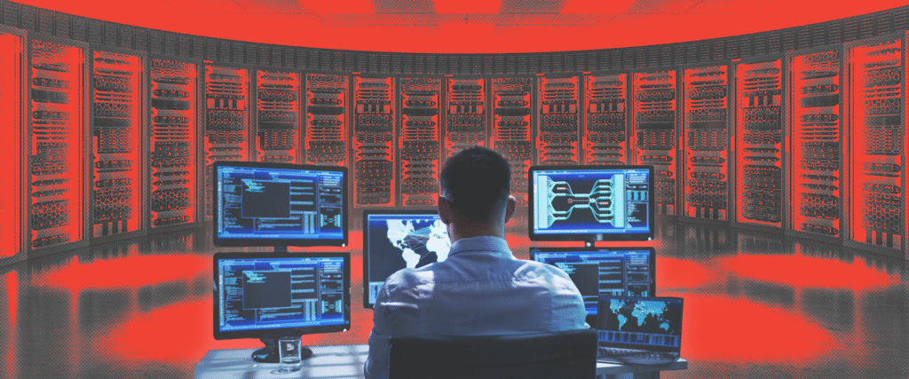 A man looks at a control panel of computers in front of racks of servers in an AI data center