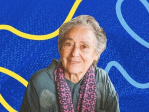 Susan Weltman with one of her woven pieces in the background